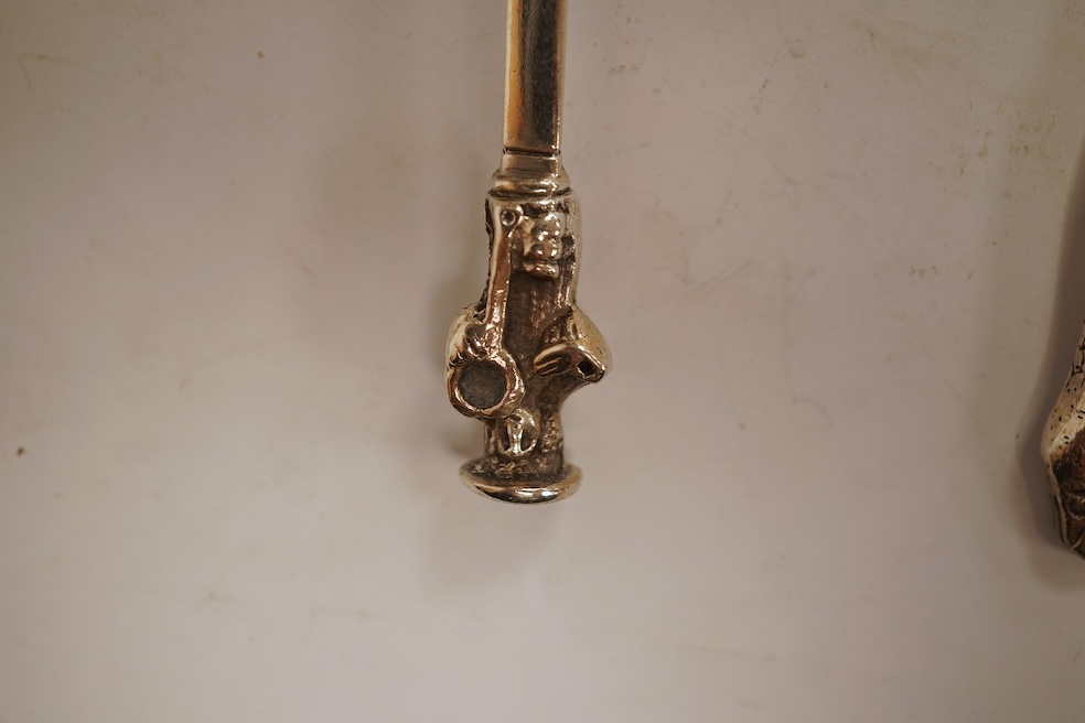 An 18th century silver apostle spoon, indistinct marks, 17cm, a continental white metal spoon with scroll handle and a pair of unmarked white metal spoons with serpent handles.